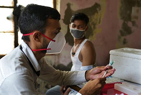 A health worker prepares to administer the vaccine for COVID-19 in New Delhi. (Photo | AP)