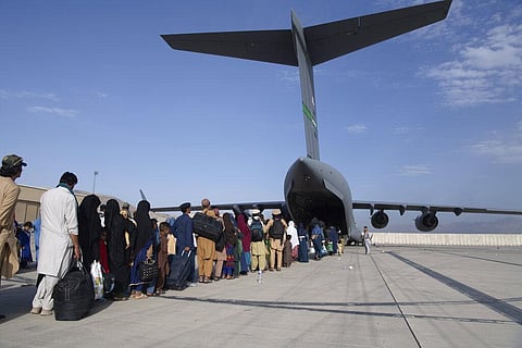 People being evacuated from Afghanistan onto a U.S. Air Force C-17 Globemaster III at Hamid Karzai International Airport in Kabul, Afghanistan. (Photo | AP)