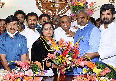 District Minister ST Somashekhar congratulates Sunanda Palanetra after her victory in the mayoral polls, in Mysuru on Wednesday | Udayshankar S