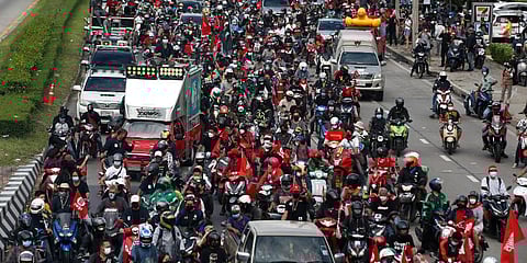Anti-government protesters block the road with cars and motorcycles as a part of their car mob demonstrations along several roads in Bangkok, Thailand. (Photo | AP)