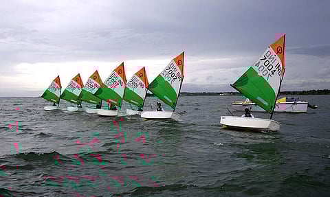 Participants with tri colour sailboats compete in the National level Multi Class Youth Sailing Championship organised by Madras Engineers Group (MEG) of Indian Army at  KRS reservoir. | Uday Shankar S