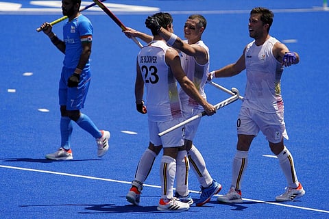 From left, Belgium's Arthur Anne-Marie Thierry de Sloover, John-John Dominique M Dohmen, and Cedric Daniel Andre Charlier celebrate after winning their men's hockey semi-final match. (Photo | AP)