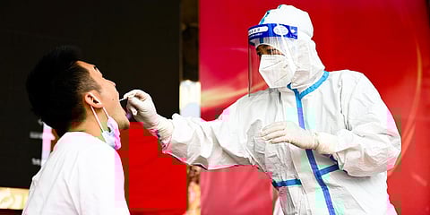 A medical worker collects a swab sample for nucleic acid test in Ruili City of southwest China's Yunnan Province. (File photo| AP)