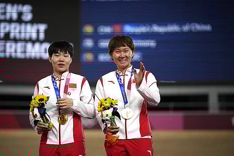 Shanju Bao, left, and Tianshi Zhong of Team China hug celebrate their gold medals during a medal ceremony. (Photo | AP)