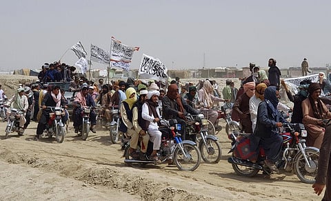 Supporters of the Taliban carry their signature white flags after the Taliban said they seized the Afghan border town of Spin Boldaka across from the town of Chaman, Pakistan. (Photo | AP)