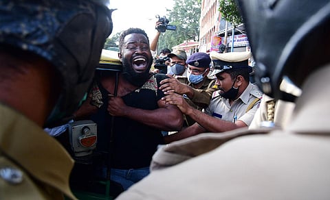 Policemen cane an African national during a protest outside the JC Nagar police station in Bengaluru. (Photo | Shriram BN)