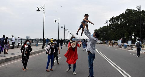 A family enjoying their time at Tank Bund Road as vehicles were diverted from the 2-km stretch on Sunday. (Photo  | S senbagapandiyan)