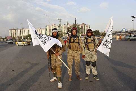Taliban fighters hold Taliban flags in Kabul, Afghanistan, Monday, Aug. 30, 2021. (Photo | AP)