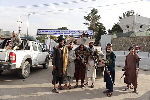 Taliban fighters stand guard in front of the Hamid Karzai International Airport after the U.S. withdrawal in Kabul, Afghanistan, Tuesday, Aug. 31, 2021. (Photo | AP)