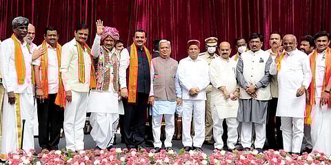 Karnataka governor Thawar Chand Gehlot and CM Basavaraj Bommai with newly inducted ministers during swearing-in ceremony to form the cabinet at Raj Bhavan. (Photo| PTI)
