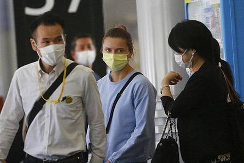 Belarusian Olympic sprinter Krystsina Tsimanouskaya, center, arrives at Narita International Airport in Narita. (Photo | AP)