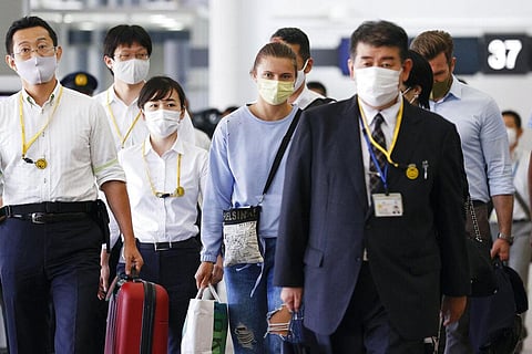 Belarusian Olympic sprinter Krystsina Tsimanouskaya, center, prepares to leave Narita International Airport in Narita. (Photo | AP)