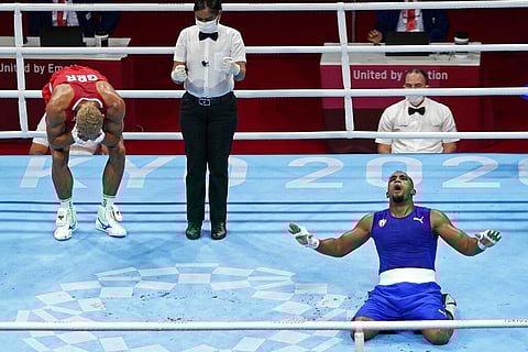 Arlen Lopez, of Cuba, right, reacts after defeating Great Britain's Benjamin Whittaker in the light heavy weight 75-81kg finals boxing match. (Photo | AP)