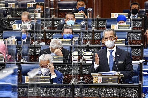 Malaysia's Prime Minister Muhyiddin Yassin wearing a face mask to help curb the spread of the coronavirus speaks at the parliamentary session at parliament house in Kuala Lumpur (Photo | AP)