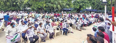 Steel plant workers staging a dharna at Andhra Bhavan in Delhi on Tuesday; (below) a protest in Vizag. (Photo | EPS)