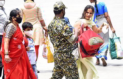 A BBMP marshal penalises a woman for not wearing mask on a crowded Bengaluru road on Tuesday. (Photo | Vinod Kumar T, EPS)