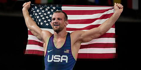 United States' David Morris Taylor III celebrates holding the US flag after winning the gold medal in the men's 86kg Freestyle wrestling event at the 2020 Olympics in Tokyo, Japan. (Photo | AP)