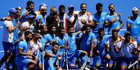 Members of the India team pose for photographs after defeating Germany 5-4 during the men's field hockey bronze medal match at the 2020 Summer Olympics in Tokyo, Japan. (Photo | AP)