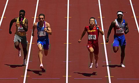 Zhiqiang Wu, of China anchors his team to win a semifinal of the men's 4 x 100-meter relay at the 2020 Summer Olympics. (Photo | AP)