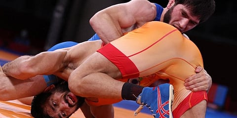 Russia's Zavur Uguev (blue) wrestles India's Kumar Ravi in their men's freestyle 57kg wrestling final match during the Tokyo 2020 Olympic Games at the Makuhari Messe in Tokyo. (Photo | AFP)