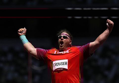 Ryan Crouser, of United States celebrates after winning the gold in the final of the men's shot put at the 2020 Summer Olympics. (Photo | AP)