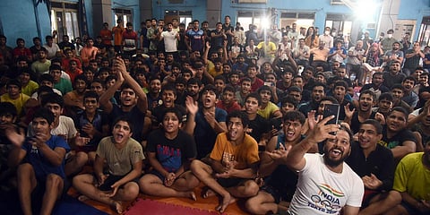 Trainees at Delhi's Chhatrasal Stadium glued to the TV during wrestler Ravi Kumar Dahiya's Olympic final bout in Tokyo. (Photo| Parveen Negi, EPS)