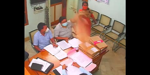 Santi throwing sand on her superior official (inset) on Thursday | Express