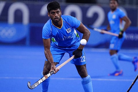 India's Varun Kumar (22) passes against Japan during a men's field hockey match at the 2020 Summer Olympics, Friday, July 30, 2021. (Photo | AP)