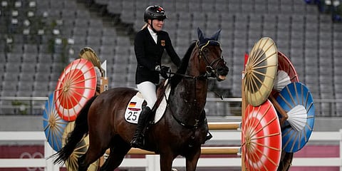 Annika Schleu of Germany cries as she couldn't control her horse to compete in the equestrian portion of the women's modern pentathlon at the 2020 Summer Olympics in Tokyo, Japan. (Photo | AP)