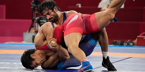 India's Bajrang Punia, top, competes against Kazakhstan's Daulet Niyazbekov during their men's freestyle 65kg wrestling bronze medal match at the 2020 Summer Olympics in Chiba, Japan. (Photo | AP)