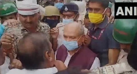 Angry locals tried to block the passage of the union minister's motorcade, threw black flags, broom, and mud on his motorcade. (Screengrab | Twitter/ANI)