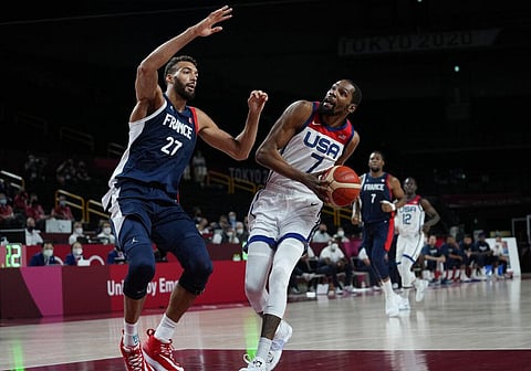 United States' Kevin Durant (7) drives around France's Rudy Gobert (27) during men's basketball gold medal game. (Photo | AP)
