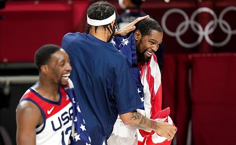 United States' Kevin Durant (7), right, celebrates with teammates after their win in the men's basketball gold medal game against France at the 2020 Olympics. (Photo | AP)
