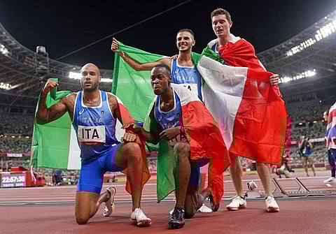 From right: Filippo Tortu, Lorenzo Patta, Eseosa Desalu, and Lamont Jacobs, of Italy celebrate after taking the gold medal in the final of the men's 4 x 100-meter relay. (Photo | AP)