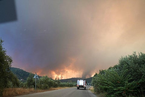 Flames approaching at Gouves village on the island of Evia, about 185 kilometers (115 miles) north of Athens, Greece, Sunday, Aug. 8, 2021. (Photo | AP)