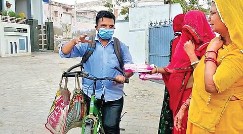 Mahendra Rathore distributes free sanirary napkins among villagers.