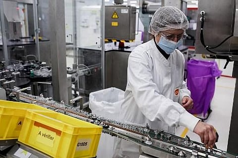 A GSK employee works on a vaccine packing line at the factory of British pharmaceutical company GlaxoSmithKline (Photo | AFP)