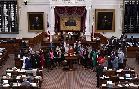 Texas state Rep. Donna Howard, D-Austin, center at lectern, stands with fellow lawmakers in the House Chamber in Austin, Texas (Photo | AP)