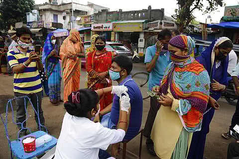 A health worker administers the vaccine for COVID-19 during a vaccination drive in Ahmedabad. (Photo | AP)