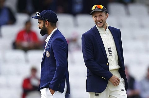 England captain Joe Root, right, laughs as he walks past India's captain Virat Kohli after the toss on the first day of third test cricket match between England and India. (Photo | AP)