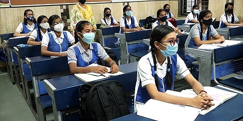 Students of class 12th being briefed on COVID-19 guidelines to be followed by them in a Delhi school. (Photo | ANI)