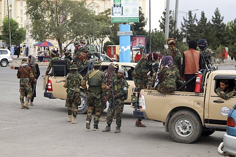 Taliban fighters arrive outside the Hamid Karzai International Airport after the U.S. military's withdrawal, in Kabul, Afghanistan. (Photo | AP)