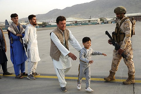 Afghans prepare to to be evacuated aboard a Qatari transport plane, at Hamid Karzai International Airport in Kabul, Afghanistan, August, 18, 2021. (Photo | AP)