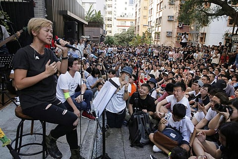 In this June 19, 2016, file photo, Cantonese pop singer and outspoken activist Denise Ho, left, performs during a free concert at a street in Hong Kong. (Photo | AP)