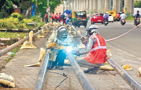 Two workers of the City Gas Project implemented by IndianOil-Adani Gas Pvt Ltd, busy welding at Edappally in Kochi | file pic