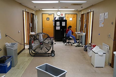 A healthcare worker sits in a hurricane damaged emergency room at Leonard J. Chabert Medical Center in the aftermath of Hurricane Ida. (Photo | AP)
