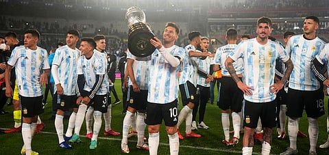 Argentina's Lionel Messi holds the Copa America trophy at the end a qualifying soccer match for the FIFA World Cup Qatar 2022, against Bolivia in Buenos Aires, Argentina, Sept 9, 2021. (Photo | AP)