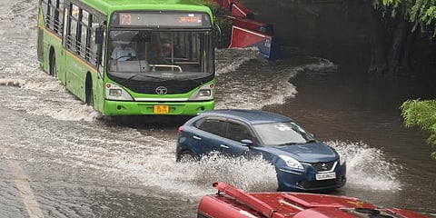 Vehicles pass through a waterlogged area following heavy rains in New Delhi. (Photo | PTI)
