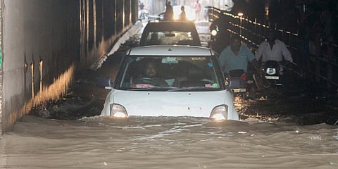 Vehicles pass through a waterlogged area following heavy rains in New Delhi. (Photo | PTI)