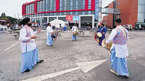 Fans play drums outside Old Trafford cricket ground after fifth and final  Test match between England and India was called off. (Photo | AP)